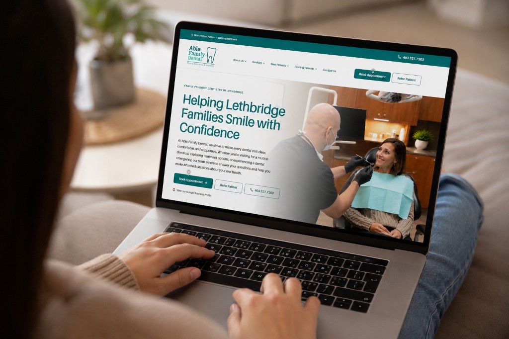 Person browsing the new Able Family Dental website on a laptop